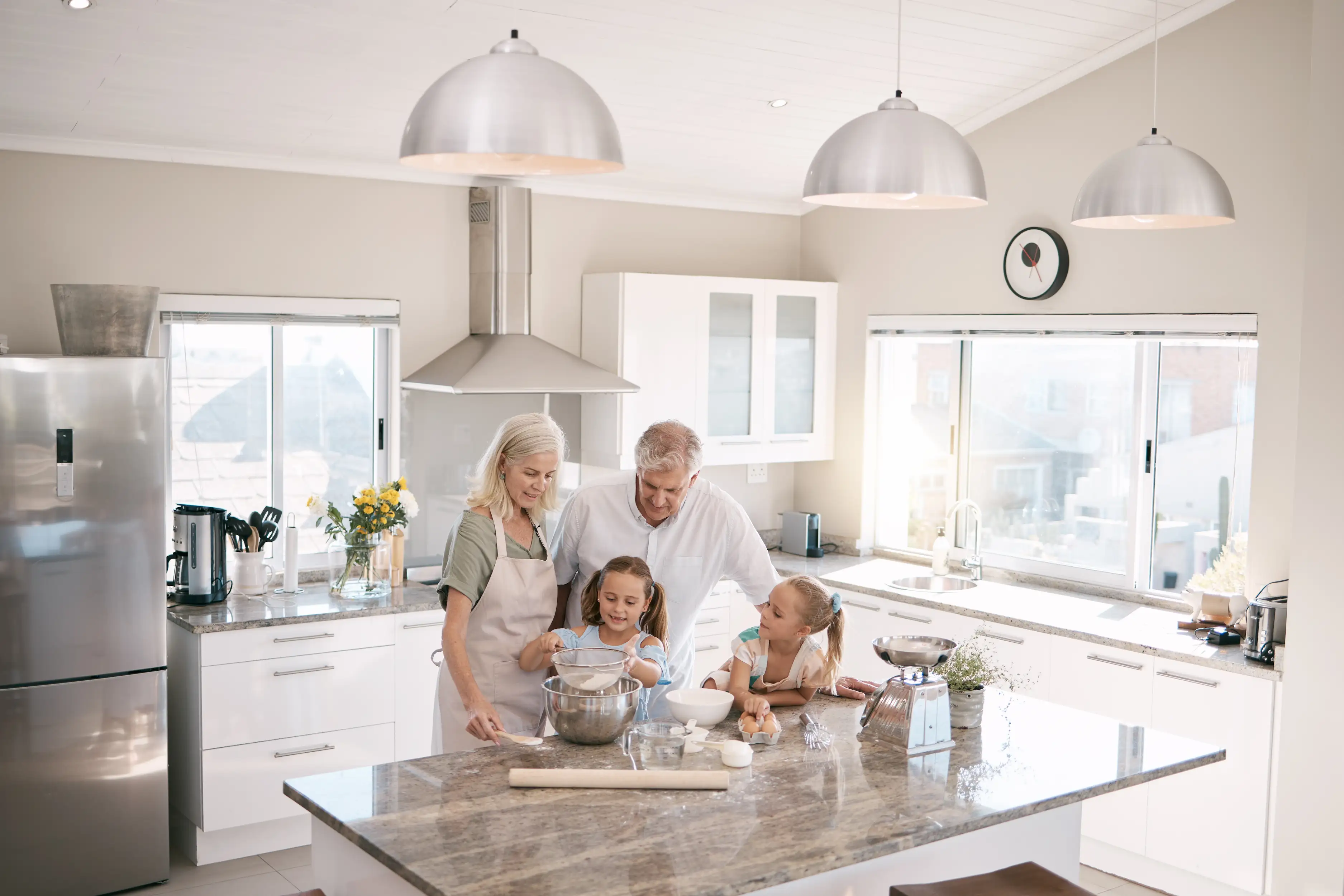 Family gathering around a stone countertop in a modern kitchen